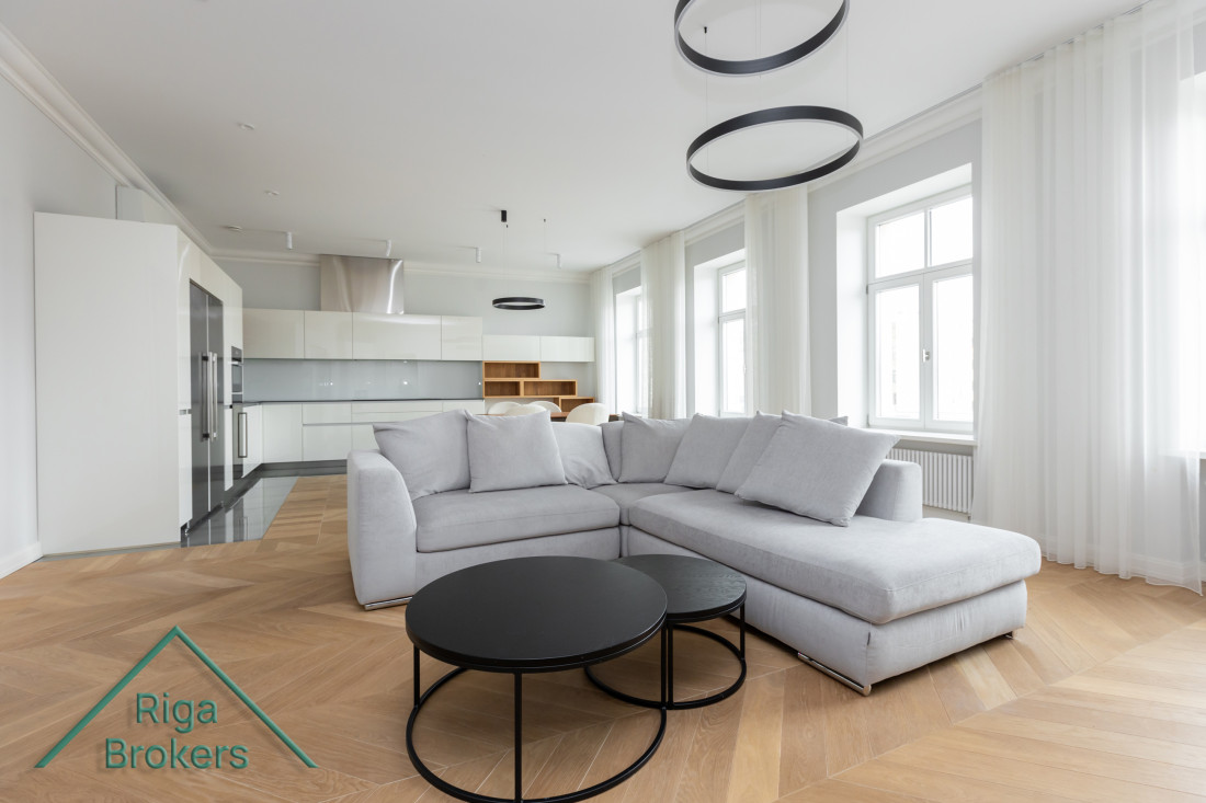 Spacious living room with gray sofa.