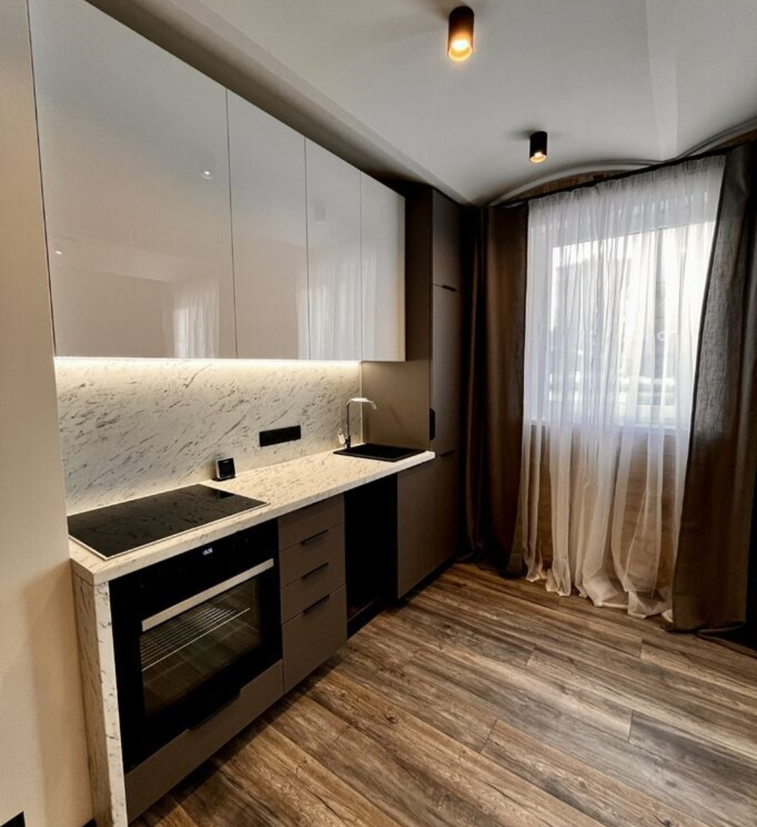 Elegant kitchen with marble countertops and modern appliances.