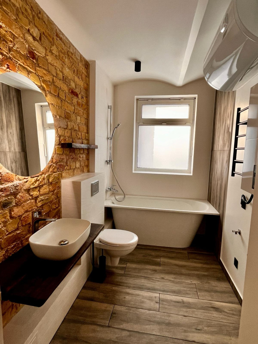 Brick wall and modern bathroom with a window.