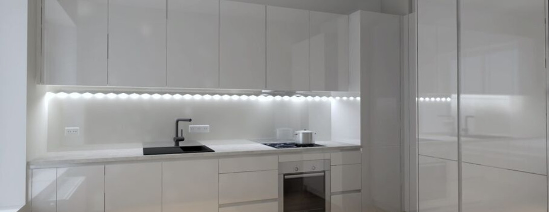  Modern kitchen with LED lighting and white furniture.