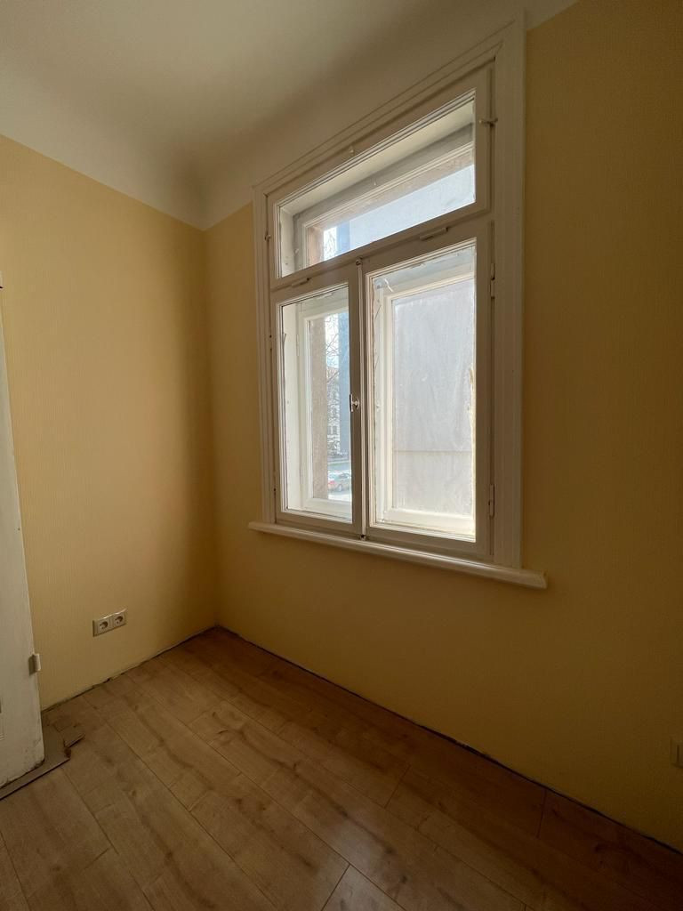 Small window in a bright room with a wooden floor.