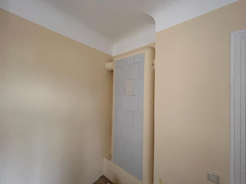 Wall niche with a light-colored stove.