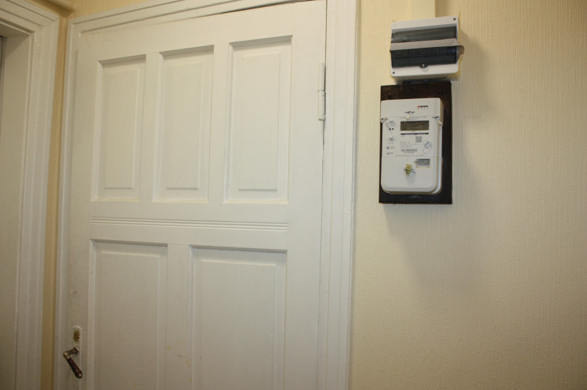 Electricity meter on the wall by the door.