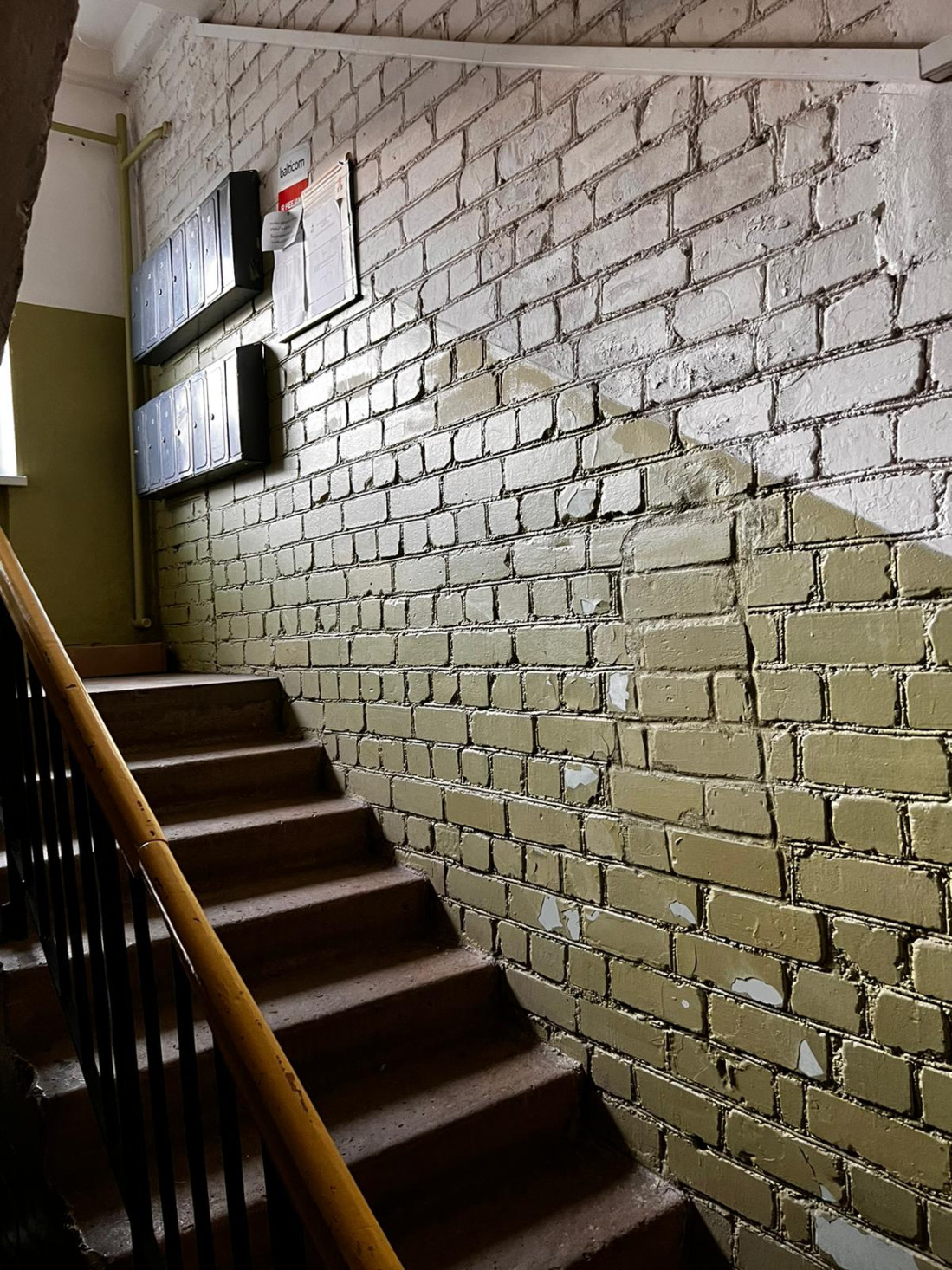 Staircase with brick walls in stairwell.