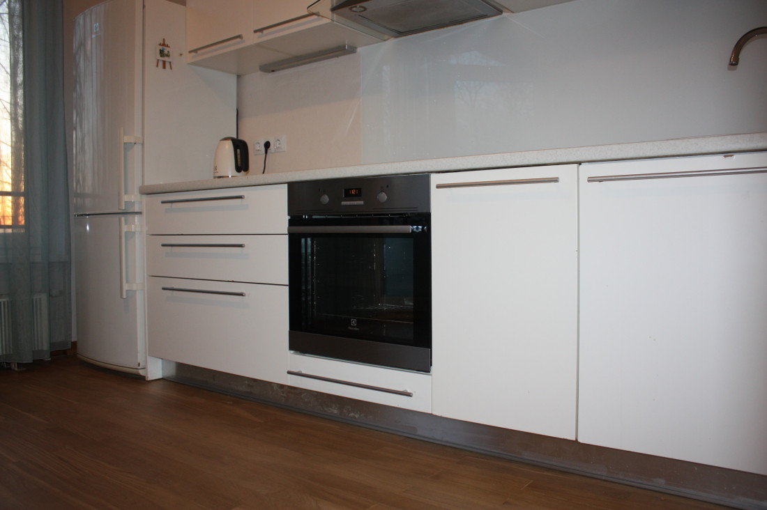 Cozy kitchen with white furniture and built-in appliances