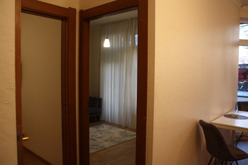 Bright room with doors and curtains.