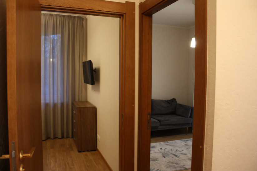 Small living room with TV and gray curtains