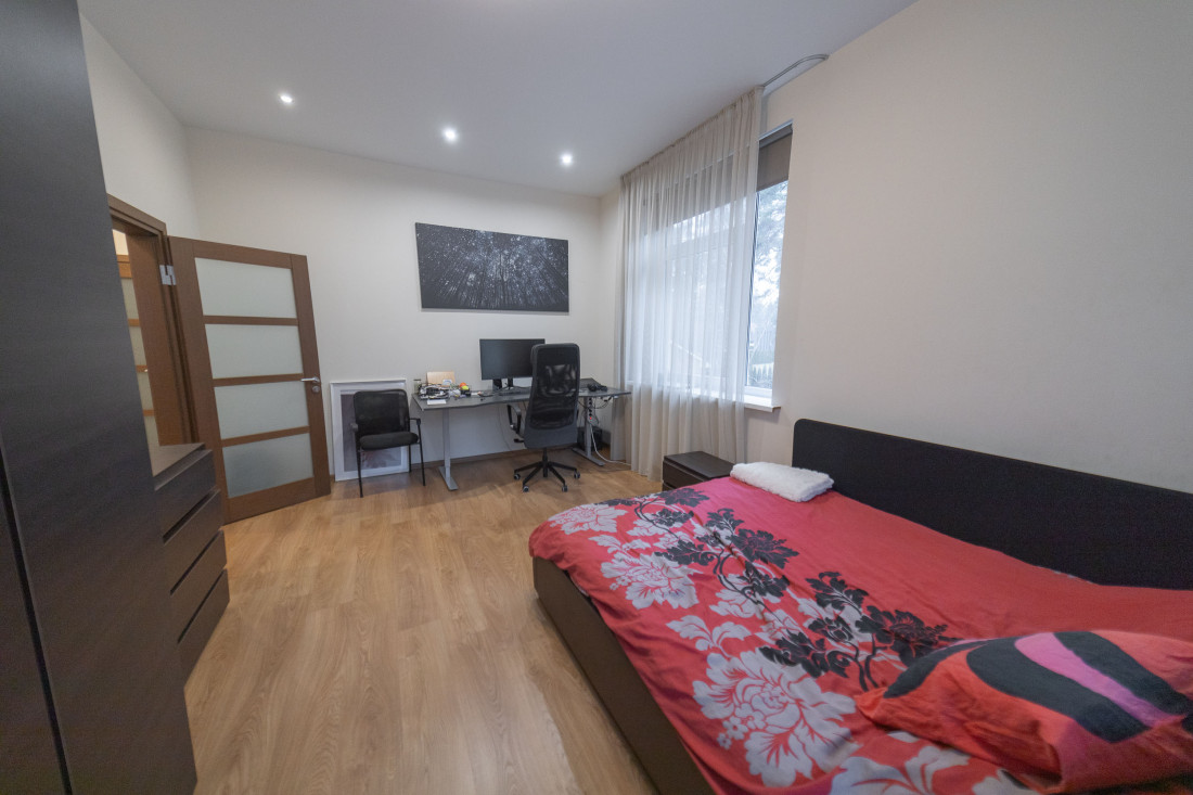 Bright bedroom with a desk by the window