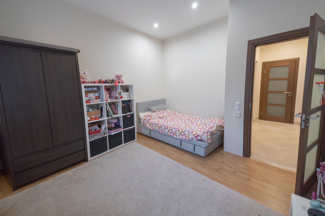 Children's room with a bed and toy shelves