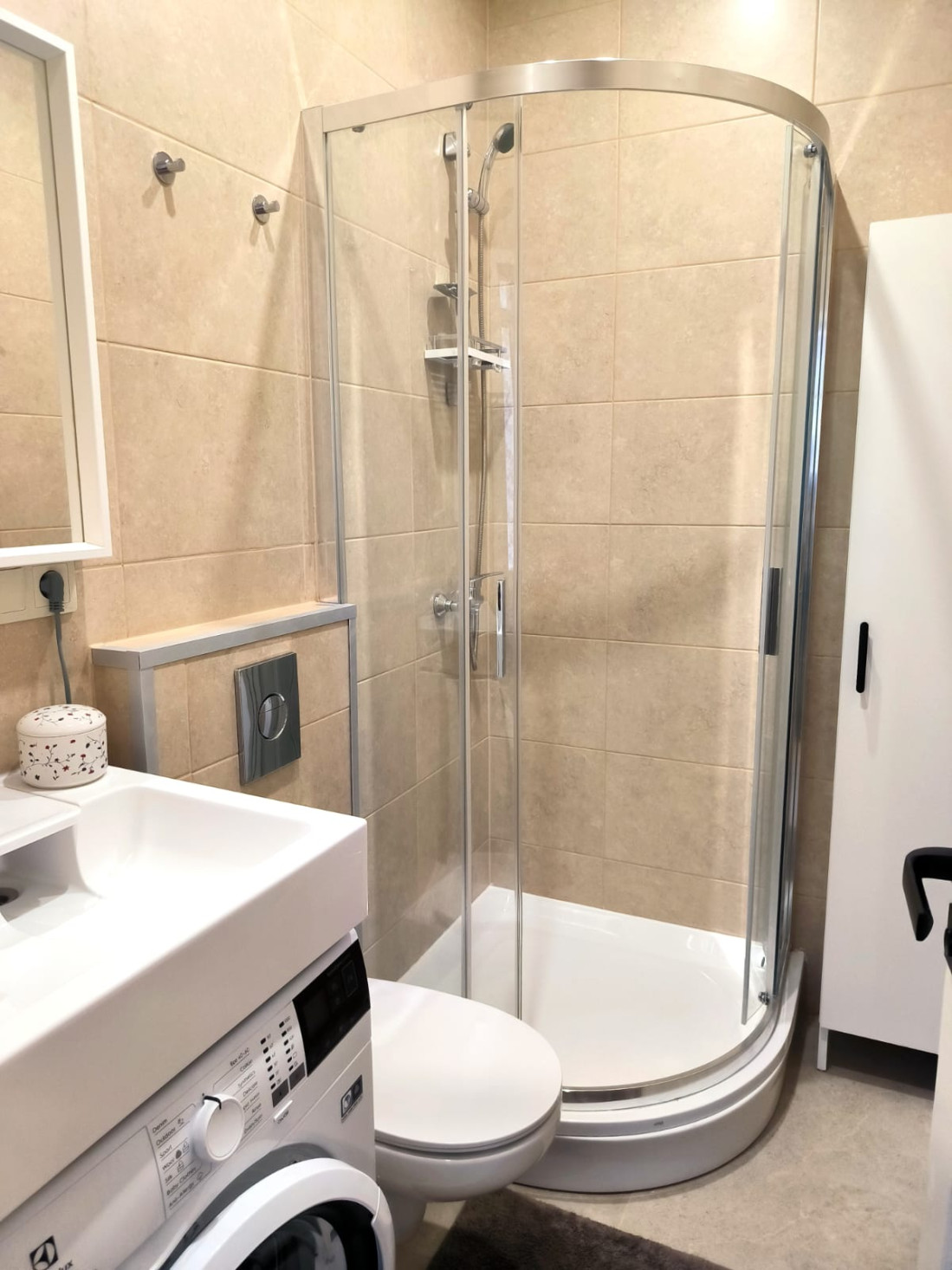  Bathroom with a corner shower enclosure.