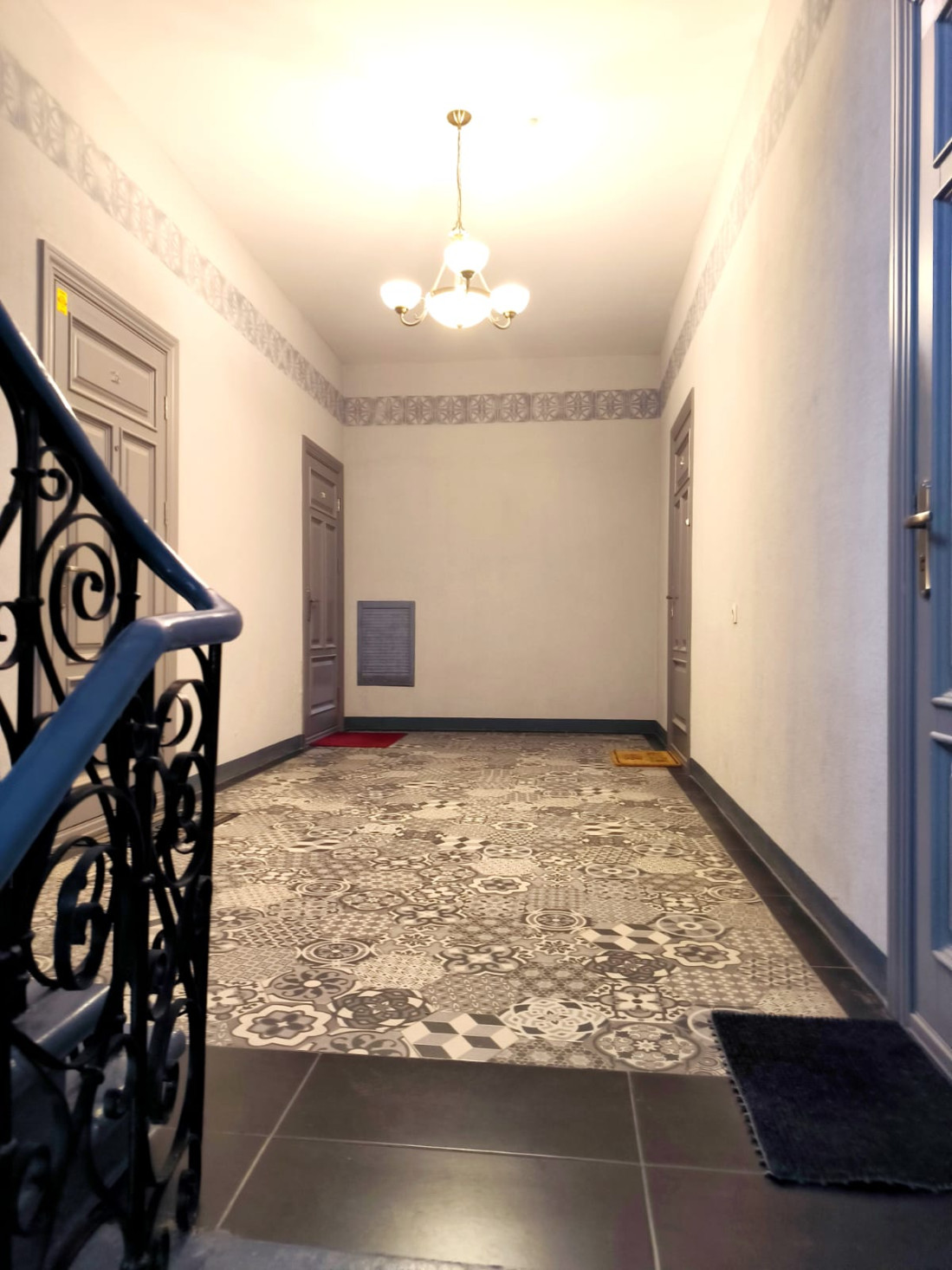 Bright stairwell with black metal railings.