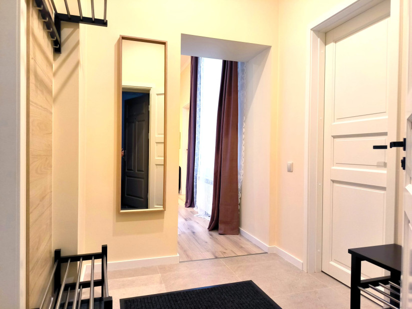  Entryway with coat rack and a mirror.