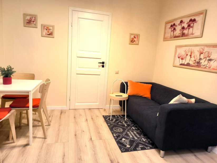  Living area with open door and art pieces.