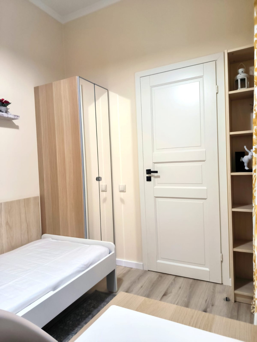 Bedroom with built-in wardrobe and bed.