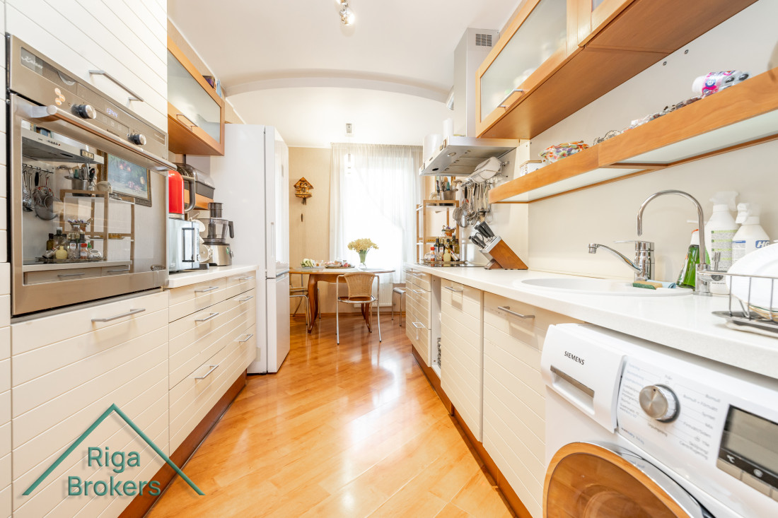 Elongated kitchen area with built-in appliances.