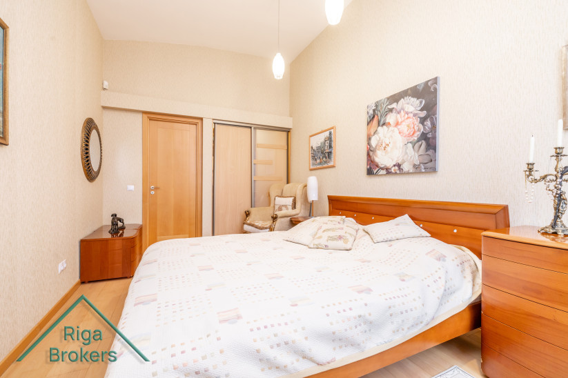 Bedroom with large bed and wall decor.