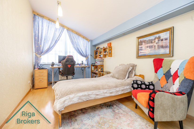 Kids' room with desk and colorful chair.