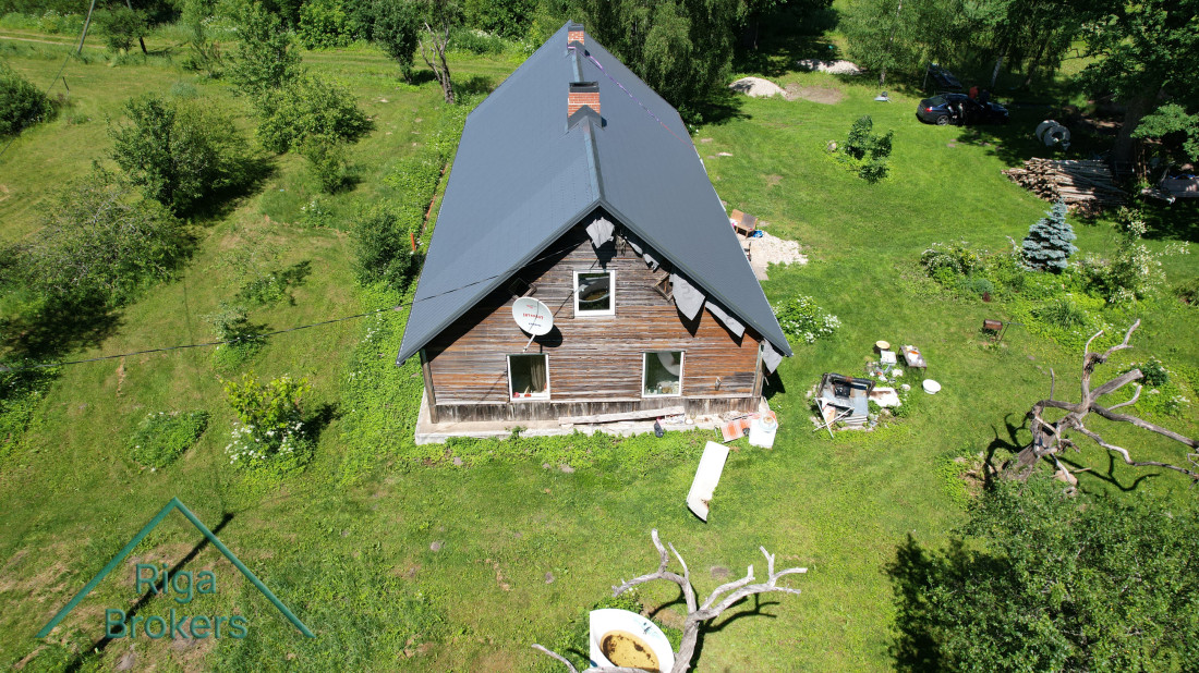  House with a metal roof and yard.