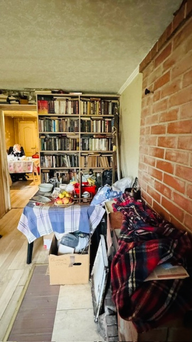 Interior view with bookshelf and table.