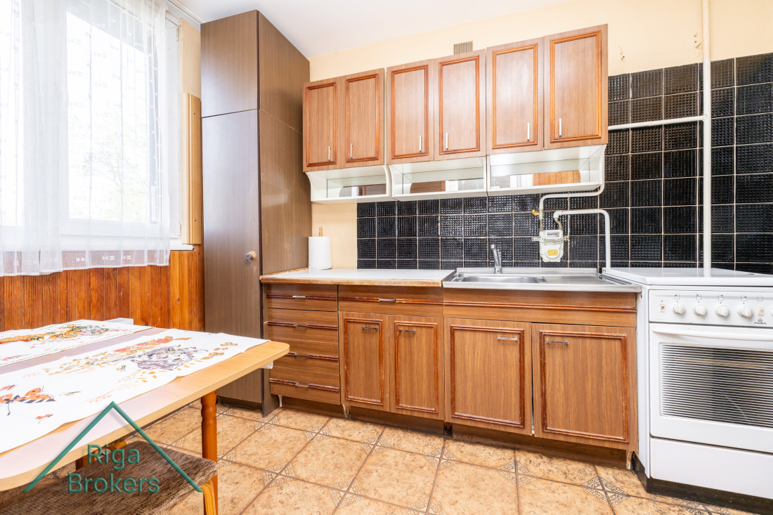 Kitchen cabinets with black tiles.