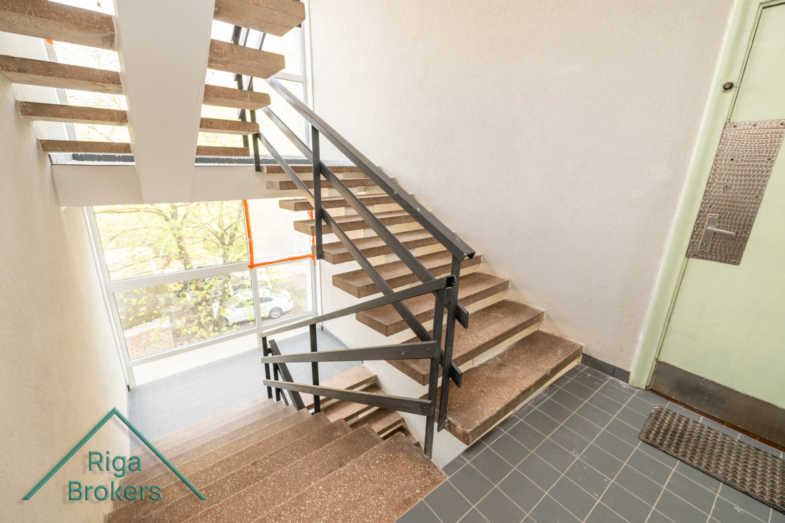 Stairs with wooden steps and metal railings.