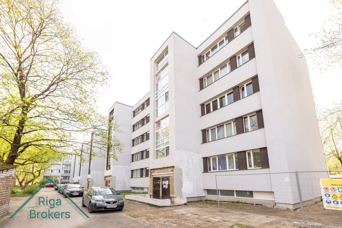 Residential building with cars parked in front. 
