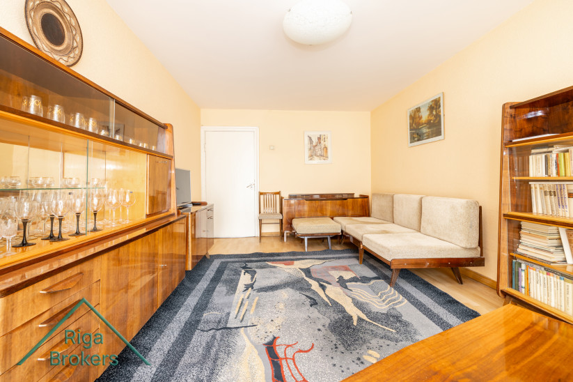 Retro furniture in a living room with glass cabinets.