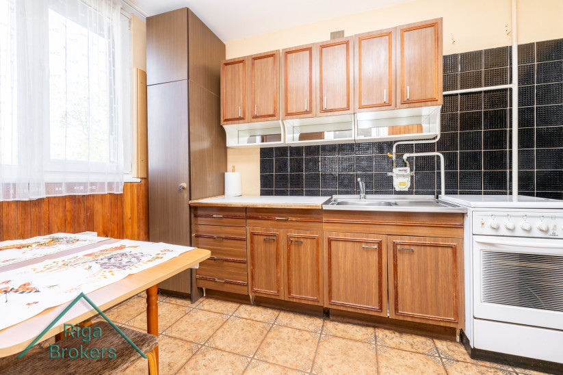 Kitchen cabinets with black tiles.