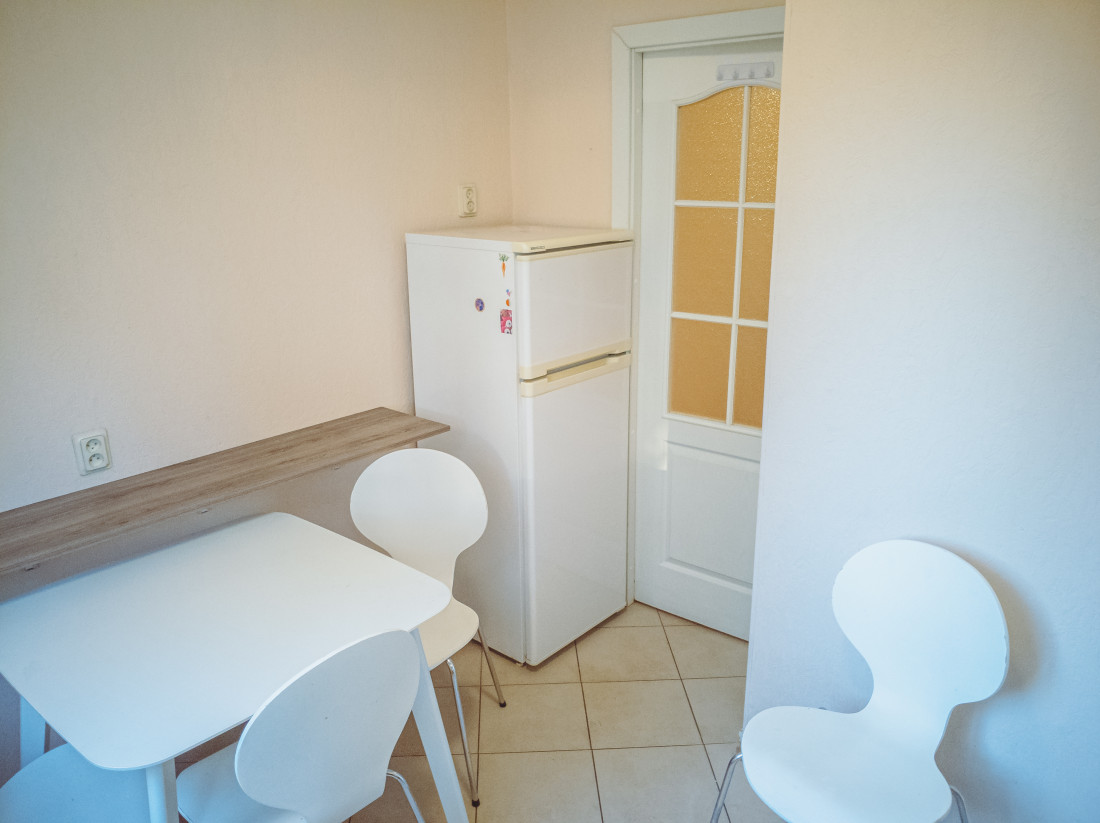Kitchen with refrigerator and window.