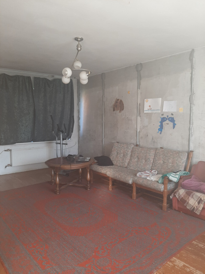 Living room with furniture and a carpet.