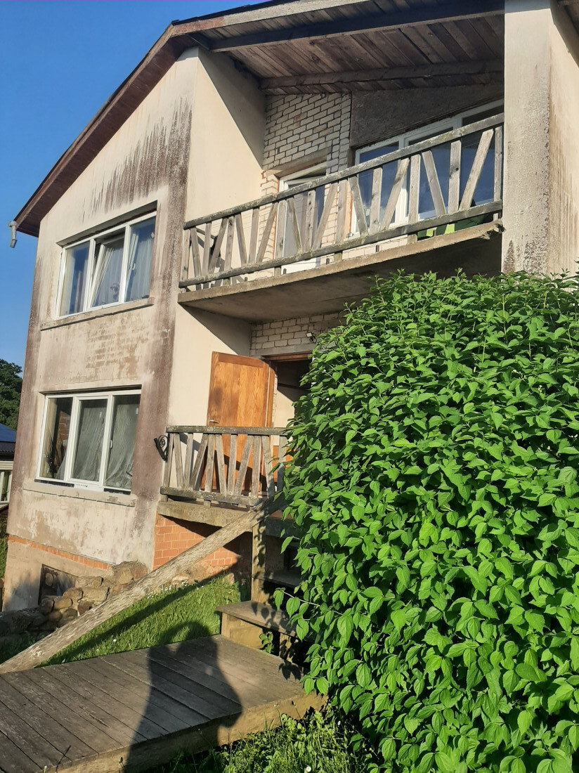 House entrance with a wooden balcony.