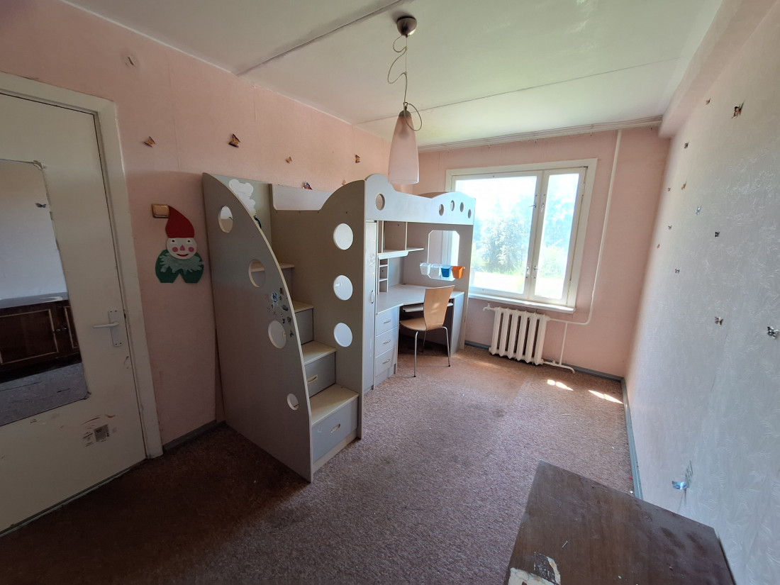 Children's room with bunk bed and desk.