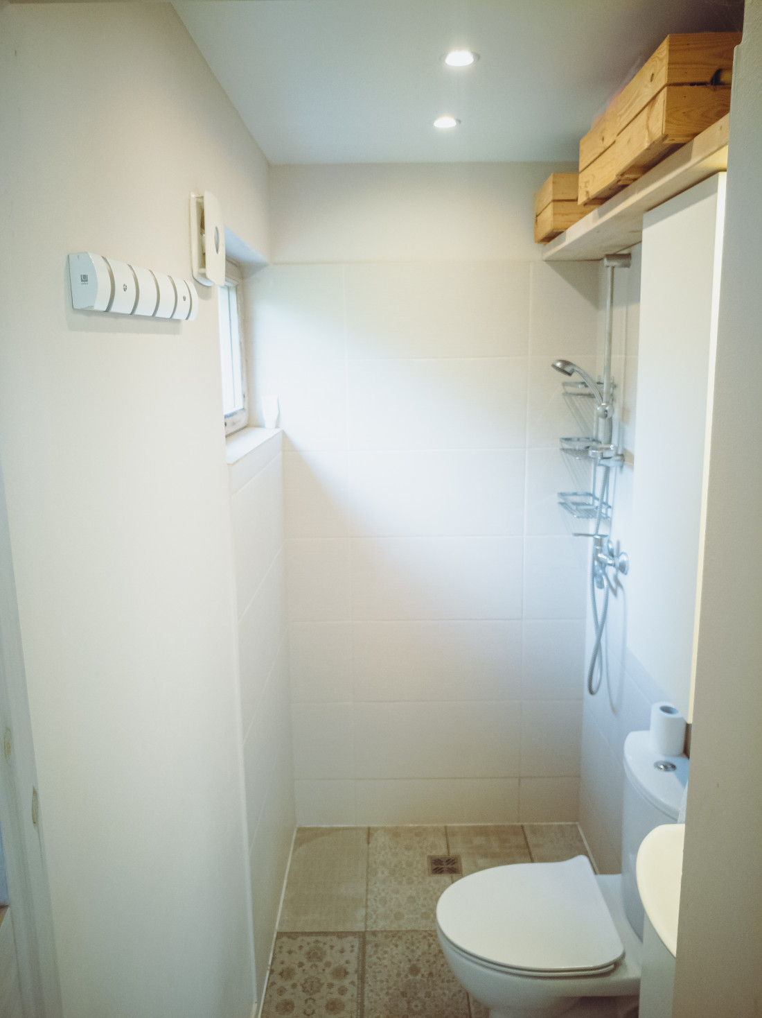 Modern bathroom with shower and shelves.