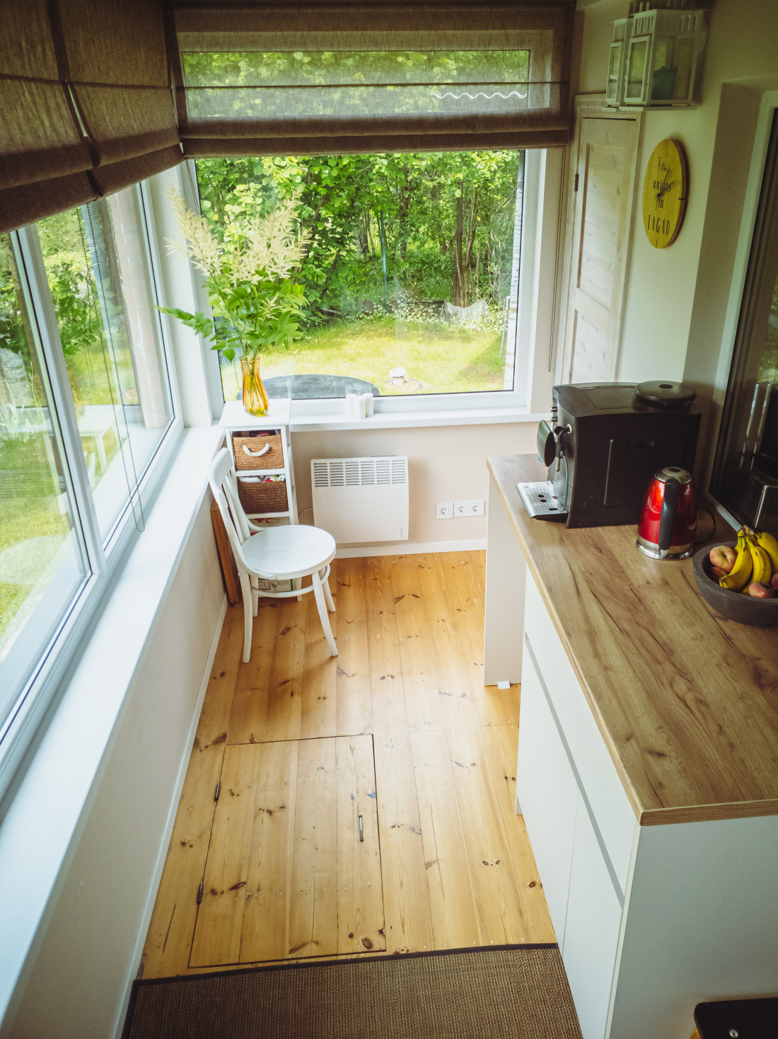 Kitchen area with windows and garden view.