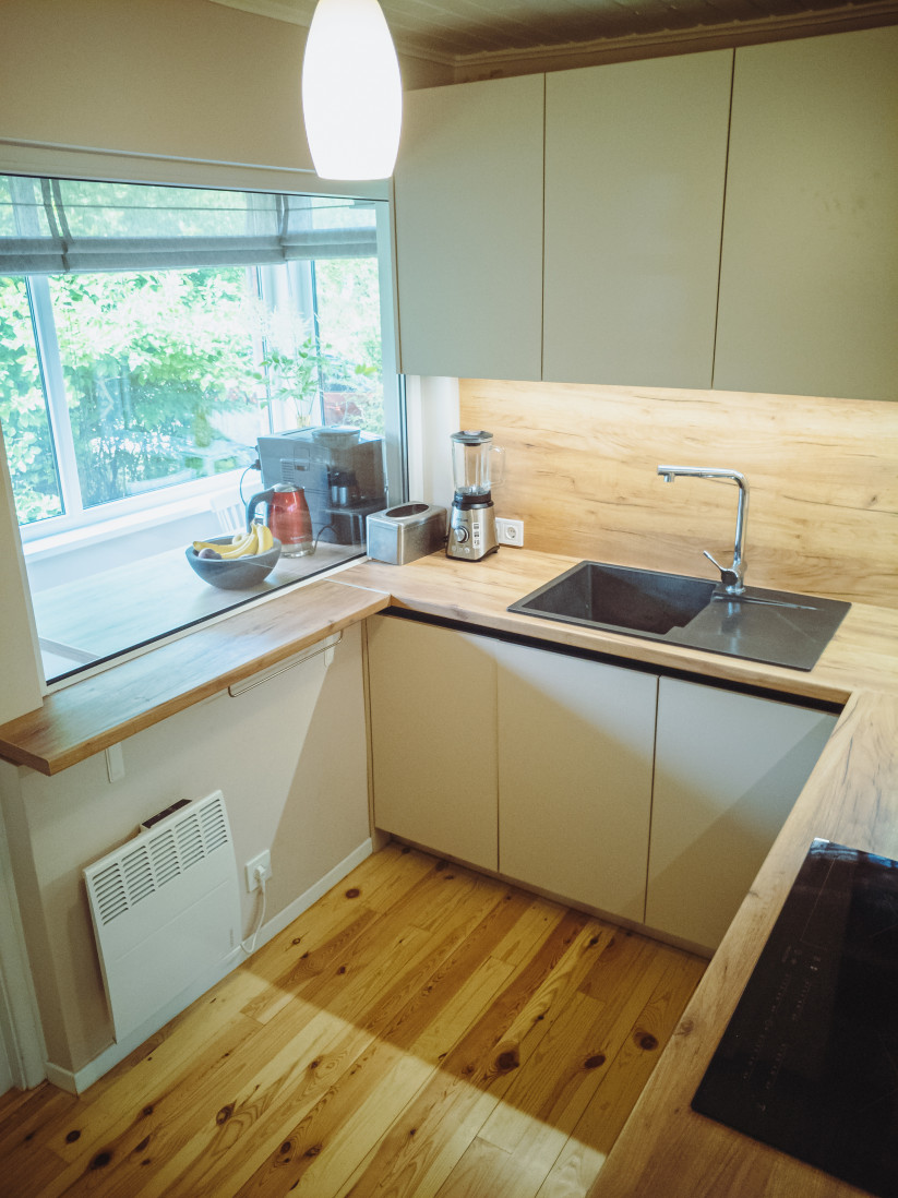 Kitchen with modern furniture and window.