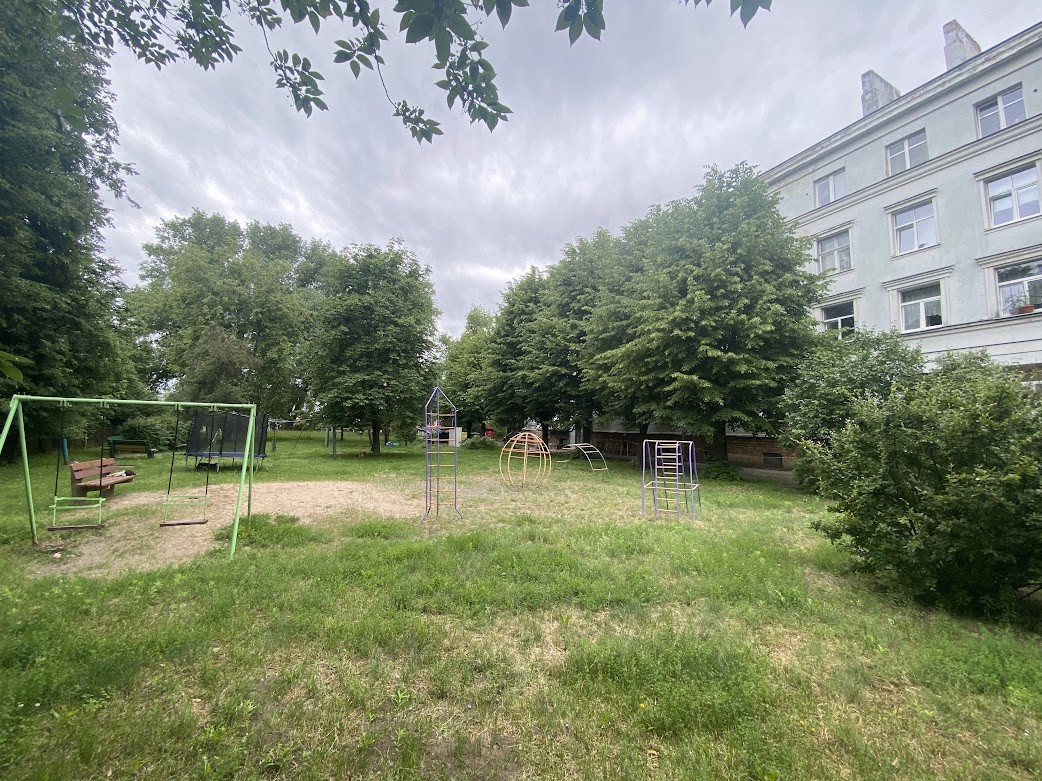 Yard with playground and trees.