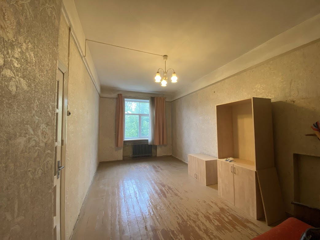 Room with a window and simple decor.