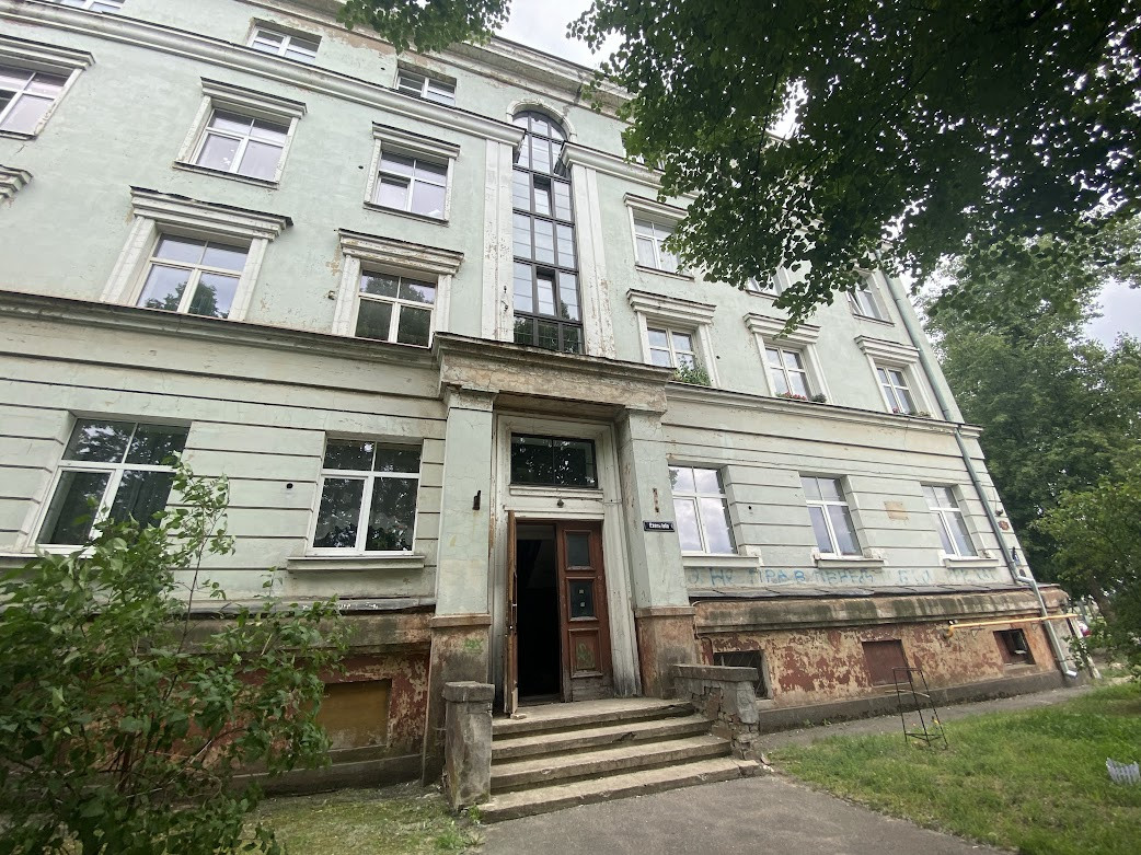 Main entrance to apartment building with stairs.