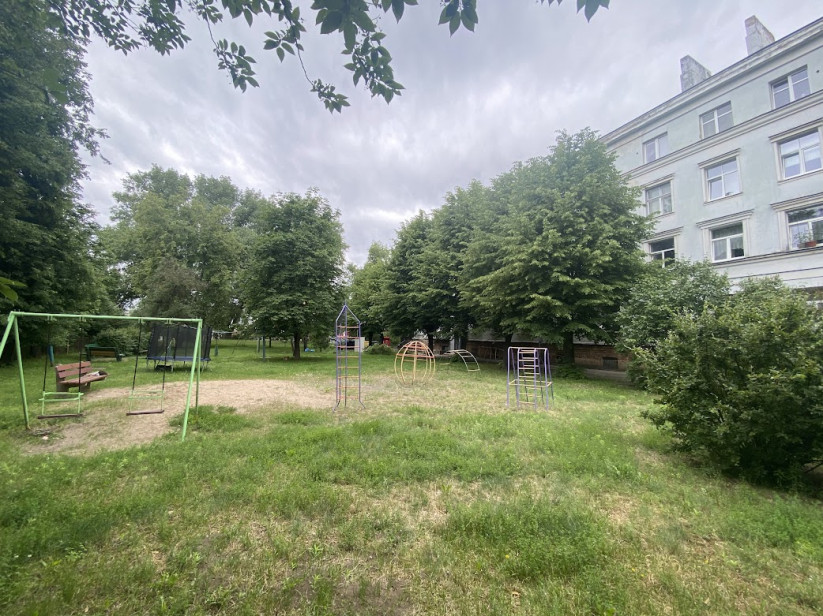 Yard with playground and trees.