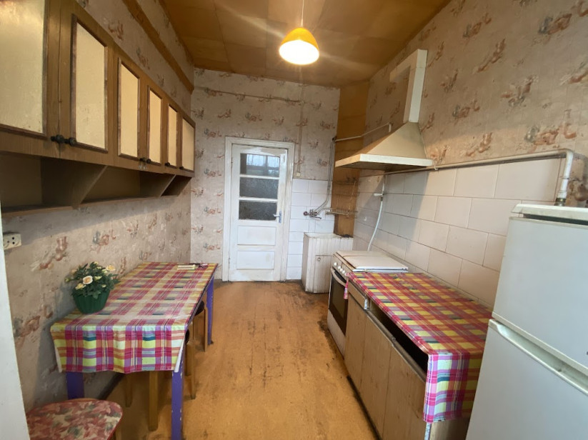 Kitchen with old furniture and tiles.