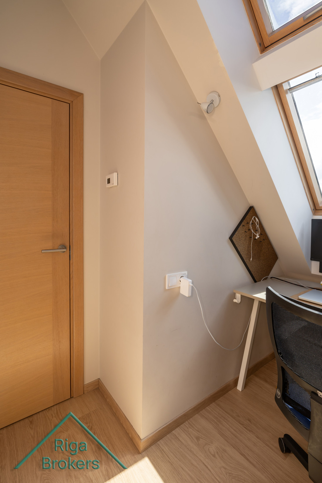 Small apartment workspace with a roof window.