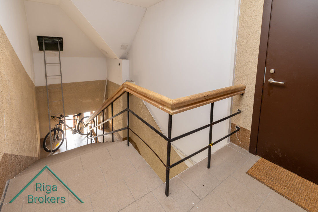 Indoor staircase with a bicycle.