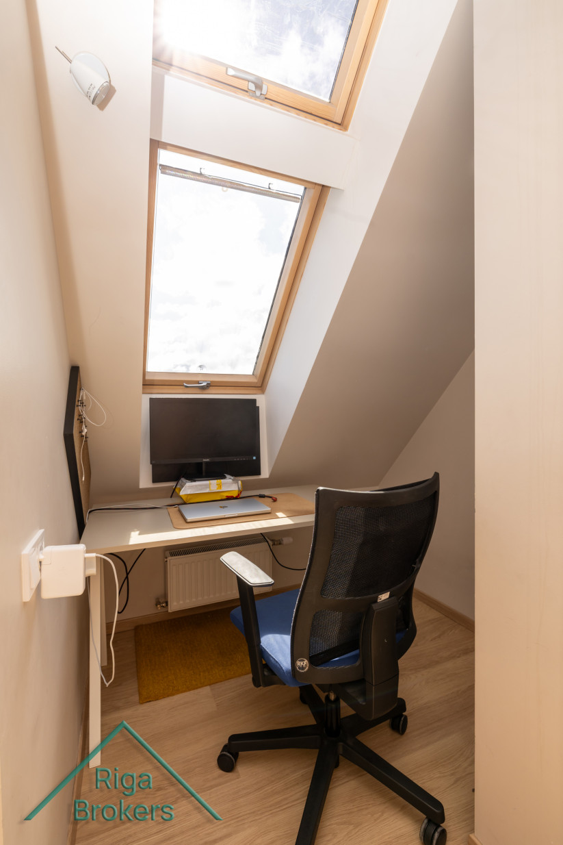 Small apartment workspace with a roof window.