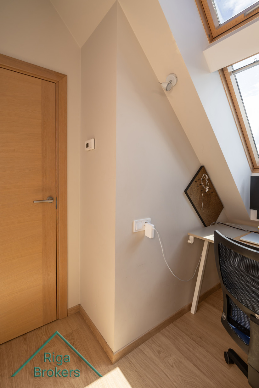 Small apartment workspace with a roof window.