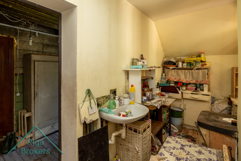 Kitchen with a sink and outdated interior.