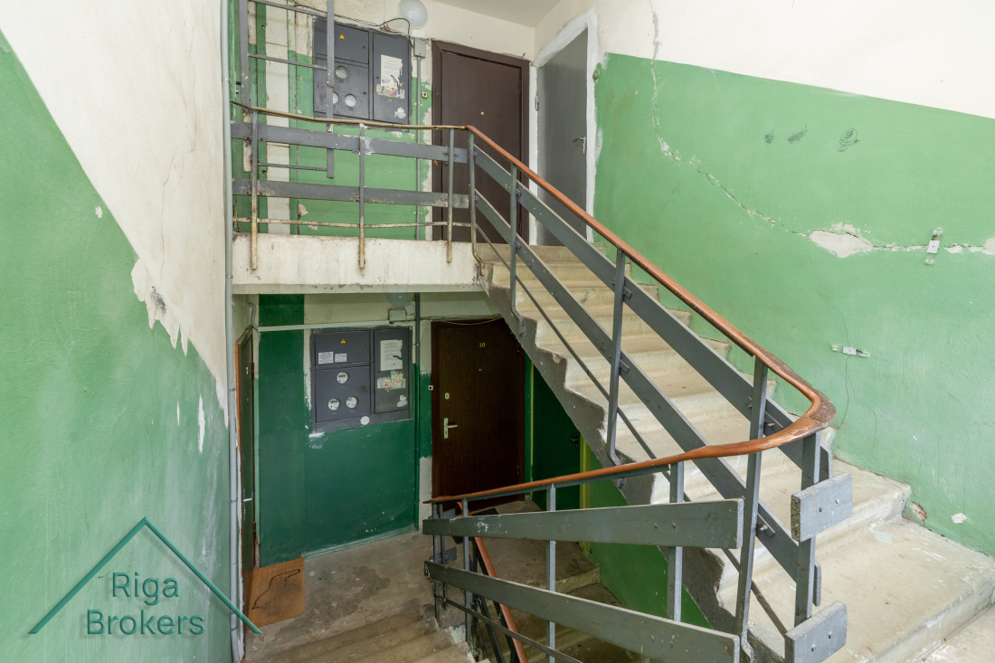 Staircase with green walls and metal railings