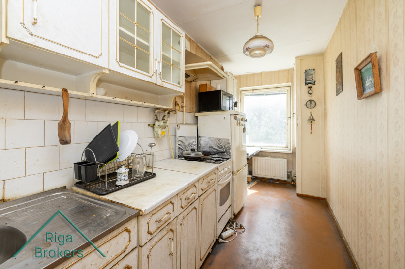 Kitchen with older furniture and appliances