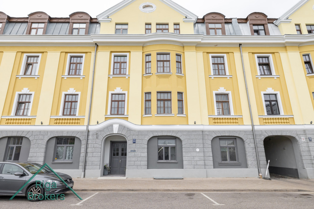 Renovated yellow building with a historic facade.