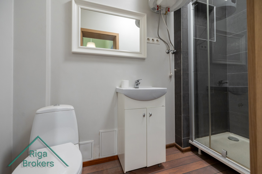 Bathroom with a mirror and shower.