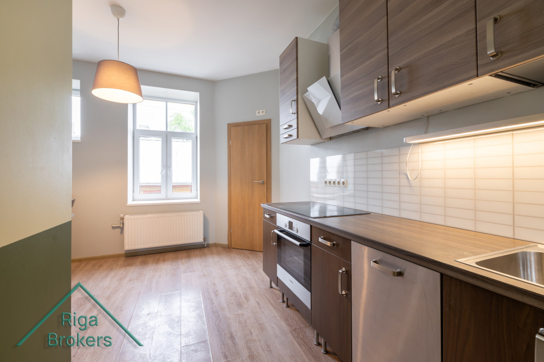  Spacious kitchen with a window and lamp.